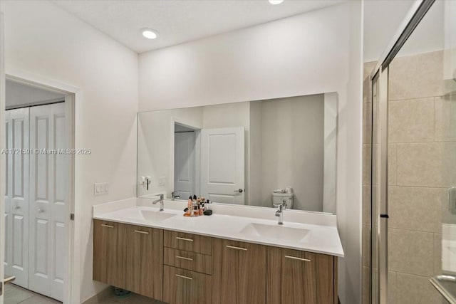 bathroom with vanity, an enclosed shower, and tile patterned flooring