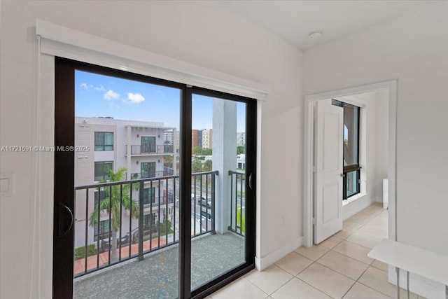 doorway to outside featuring light tile patterned floors and a wealth of natural light