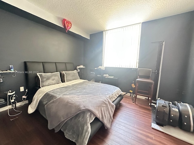 bedroom with hardwood / wood-style flooring and a textured ceiling