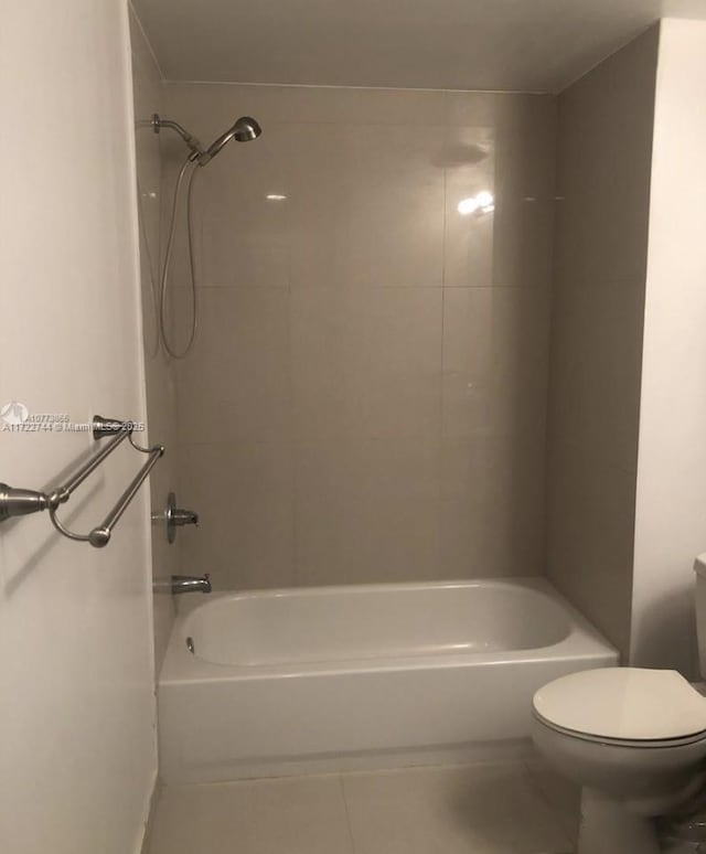 full bathroom featuring toilet, tile patterned flooring, and tub / shower combination