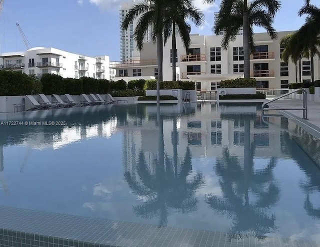 view of swimming pool with a water view