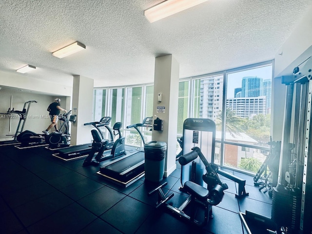 exercise room featuring floor to ceiling windows, plenty of natural light, and a textured ceiling