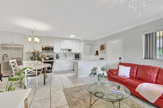 living room featuring a notable chandelier, crown molding, and sink