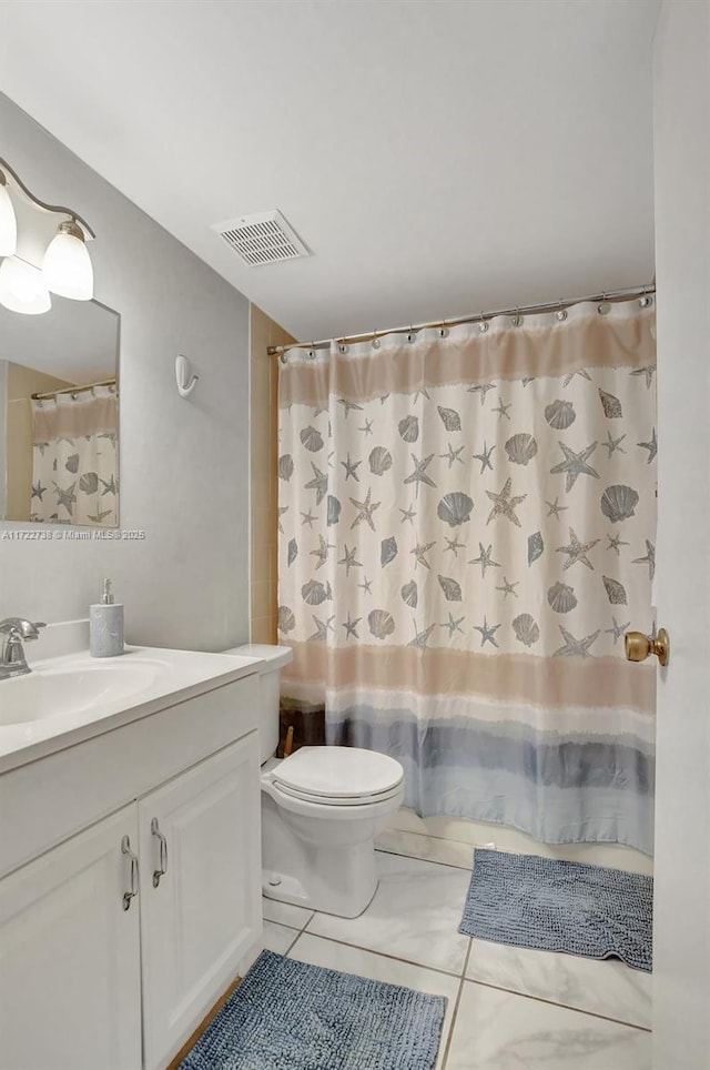 bathroom featuring tile patterned floors, vanity, a shower with shower curtain, and toilet