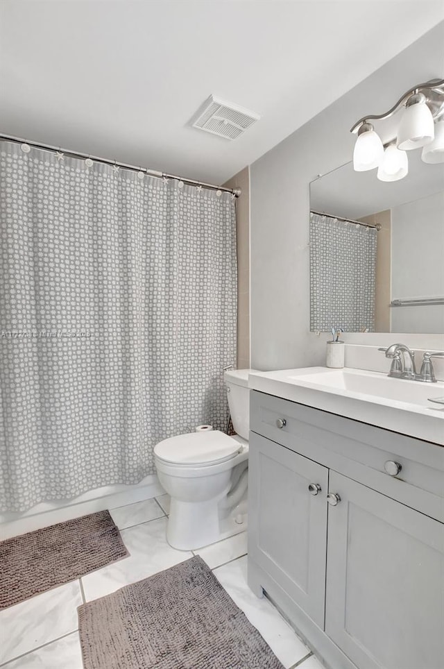 bathroom with tile patterned floors, vanity, and toilet