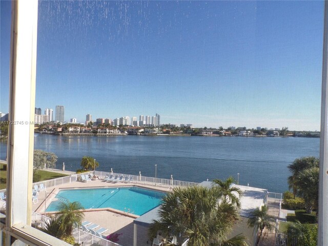 view of swimming pool with a water view