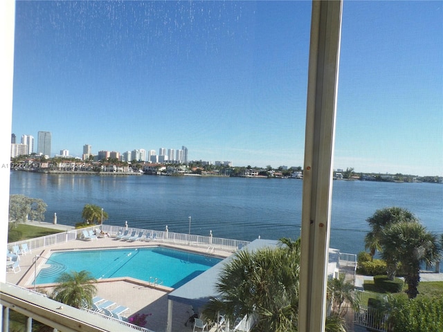 view of swimming pool with a water view and a patio