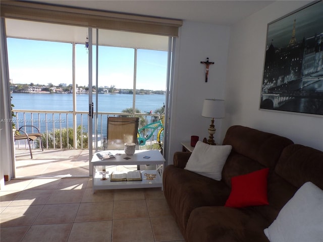 tiled living room with a water view and a healthy amount of sunlight