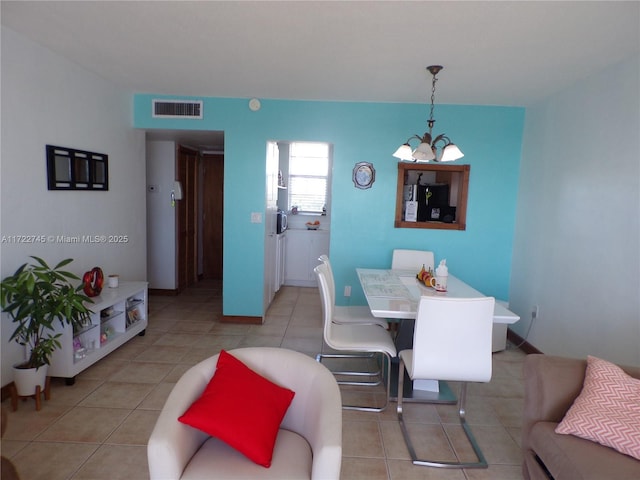 3010 Marcos Dr Unit R412, Aventura, FL 33160 - dining area with light tile patterned floors, visible vents, and a notable chandelier