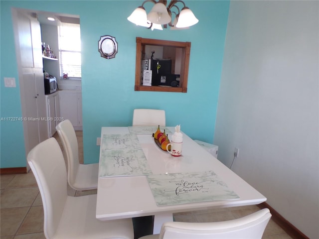 3010 Marcos Dr Unit R412, Aventura, FL 33160 - dining space with light tile patterned floors, baseboards, and a notable chandelier