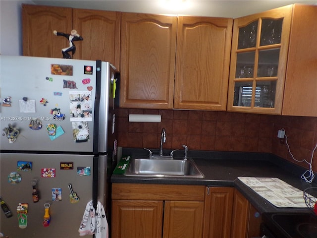 3010 Marcos Dr Unit R412, Aventura, FL 33160 - kitchen with a sink, tasteful backsplash, dark countertops, freestanding refrigerator, and glass insert cabinets