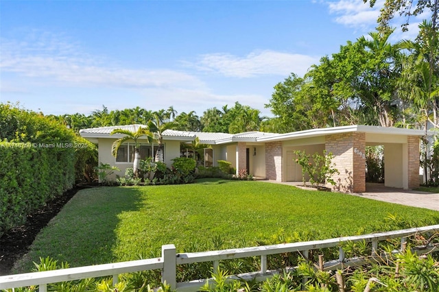 ranch-style home featuring a carport and a front lawn