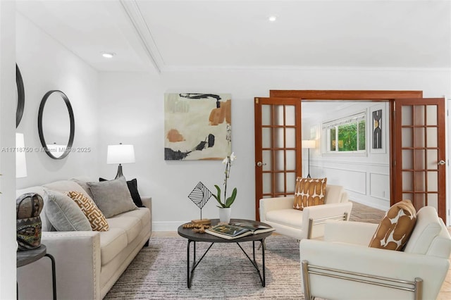 living room with ornamental molding and french doors