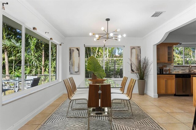 tiled dining area featuring an inviting chandelier and ornamental molding