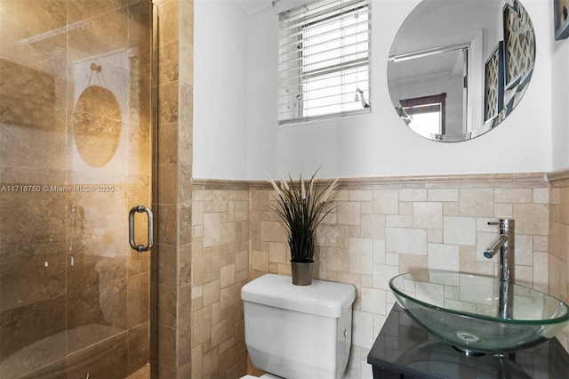 bathroom with an enclosed shower, toilet, sink, and tile walls