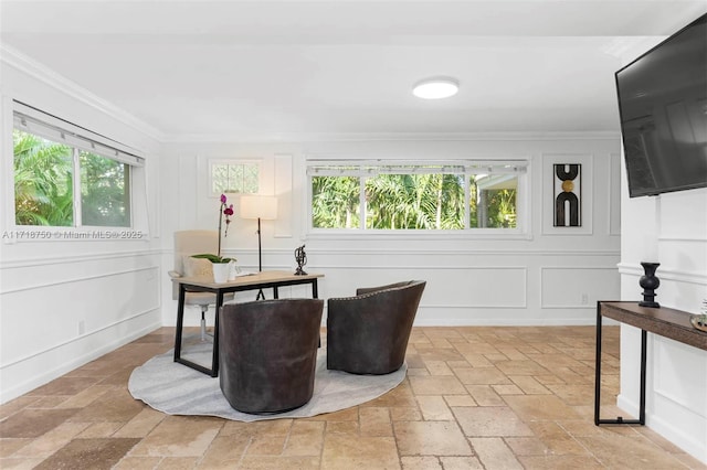 sitting room with a healthy amount of sunlight and ornamental molding