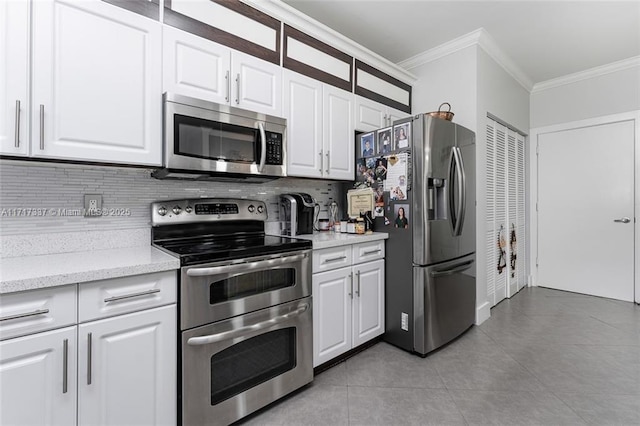 kitchen featuring stainless steel appliances, white cabinets, light tile patterned floors, backsplash, and crown molding