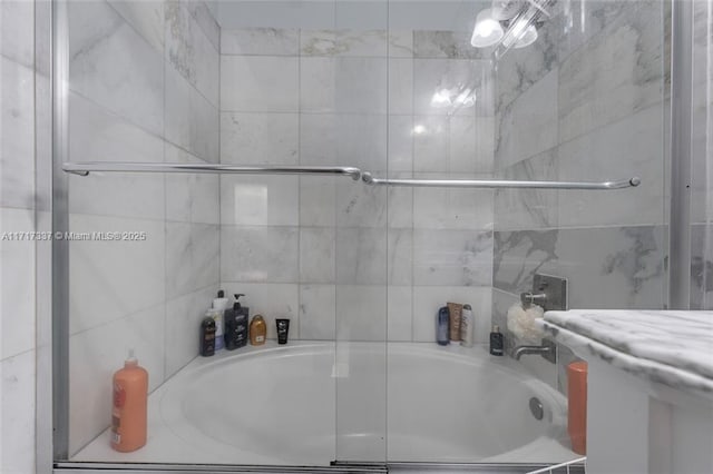 bathroom with shower / bath combination with glass door