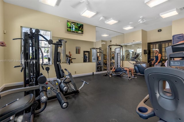 workout area with visible vents, baseboards, and french doors