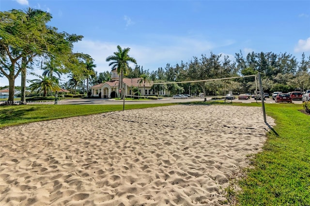 view of community featuring volleyball court and a lawn