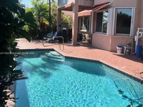 view of swimming pool with a patio area