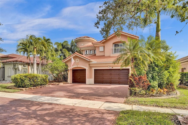 mediterranean / spanish-style house with a garage