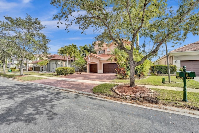 view of front of property with a front lawn and a garage