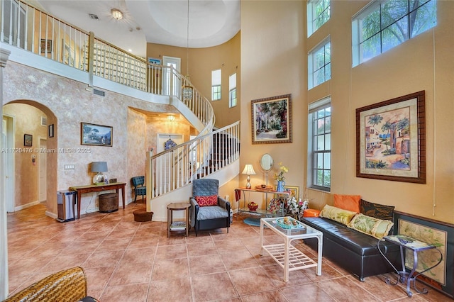 living room with tile patterned floors and a high ceiling