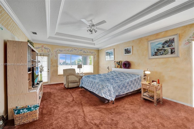 carpeted bedroom featuring ceiling fan, crown molding, and a tray ceiling