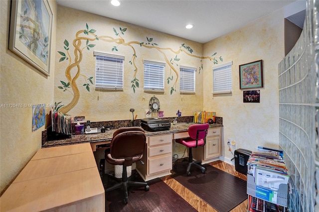 office space with built in desk and wood-type flooring