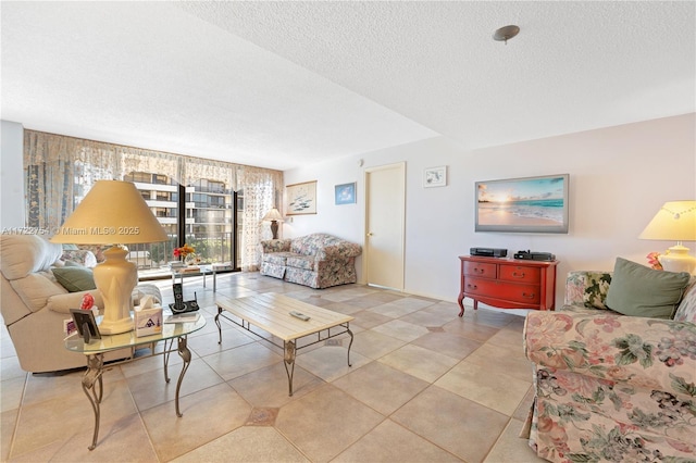 tiled living room featuring a textured ceiling