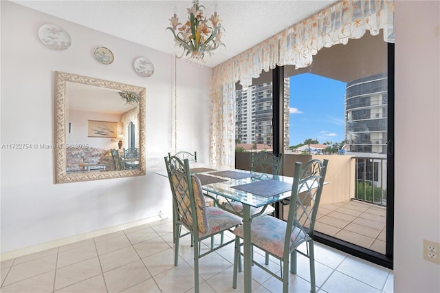 dining space with a textured ceiling and tile patterned floors