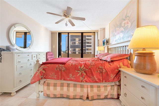 bedroom with floor to ceiling windows, a textured ceiling, and ceiling fan