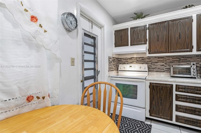 kitchen with decorative backsplash, dark brown cabinets, white electric stove, and light tile patterned flooring