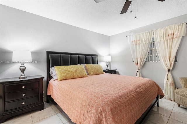 bedroom with light tile patterned floors, a textured ceiling, and ceiling fan