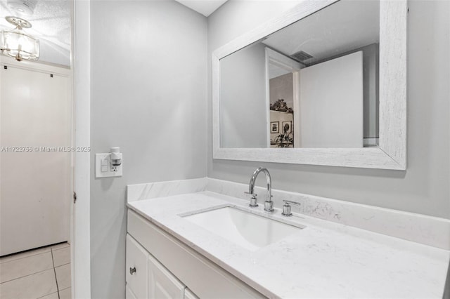 bathroom featuring tile patterned flooring, a textured ceiling, and vanity