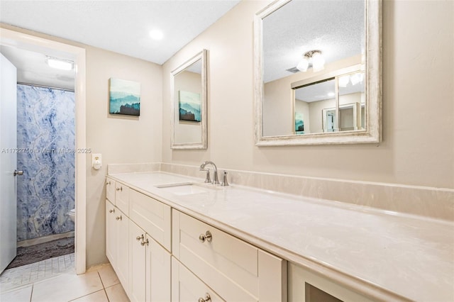 bathroom featuring walk in shower, tile patterned flooring, a textured ceiling, toilet, and vanity