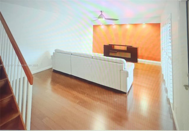 living room with ceiling fan and wood-type flooring