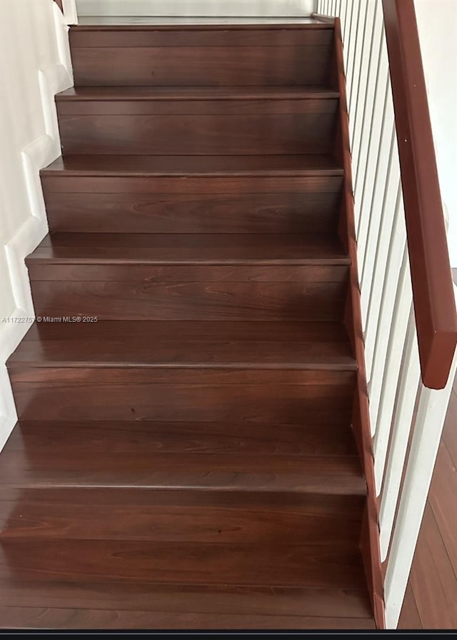 stairs with hardwood / wood-style floors