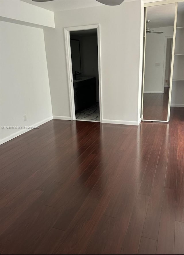 empty room featuring dark hardwood / wood-style floors and ceiling fan