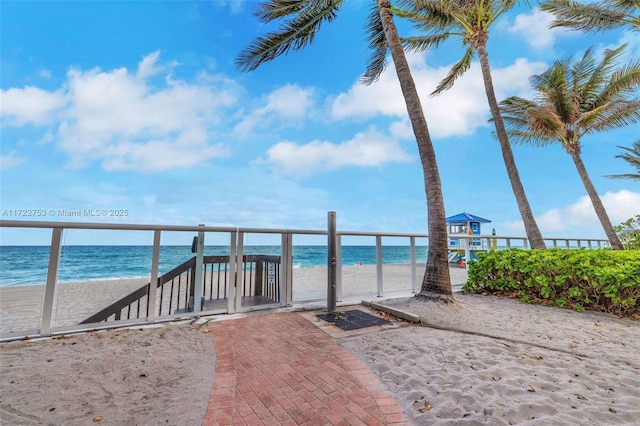 exterior space featuring a water view and a beach view