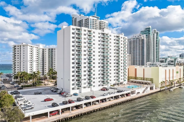 view of building exterior with a water view and a city view