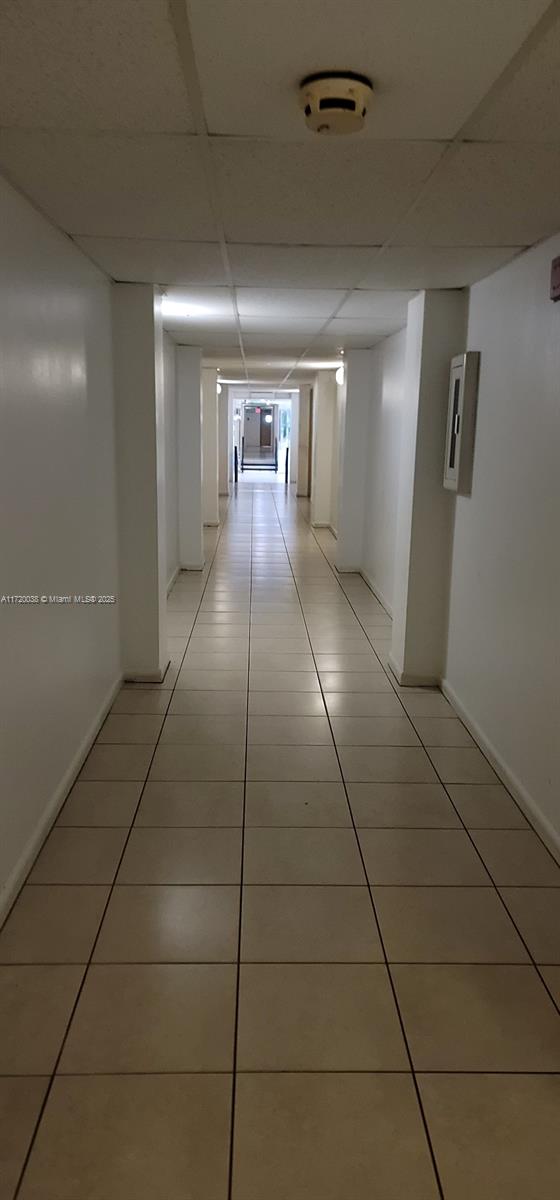 hall featuring light tile patterned flooring