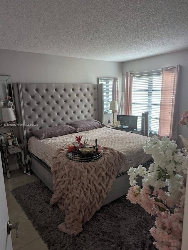 bedroom featuring a textured ceiling and multiple windows