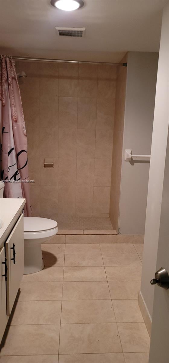 bathroom featuring vanity, tile patterned floors, and walk in shower