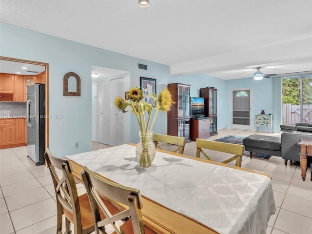 dining area with ceiling fan and light tile patterned floors