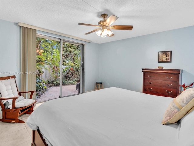 tiled bedroom featuring ceiling fan, a textured ceiling, and access to outside