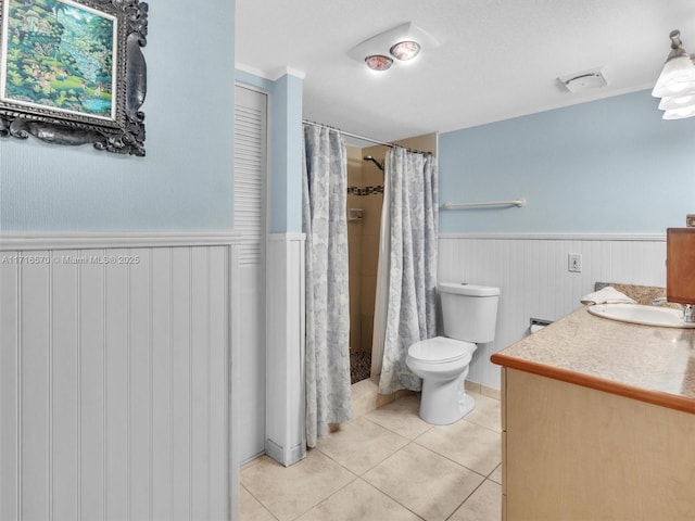 bathroom with toilet, vanity, tile patterned flooring, and walk in shower