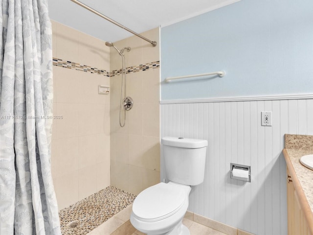 bathroom with toilet, vanity, tile patterned floors, and curtained shower