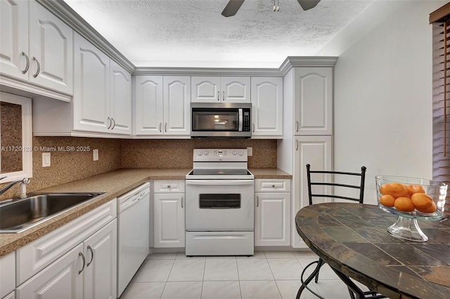 kitchen featuring backsplash, white appliances, sink, white cabinets, and light tile patterned flooring